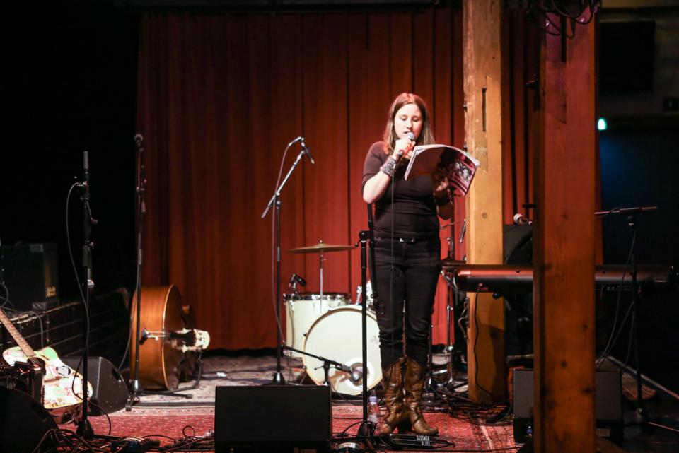 Woman with a microphone during her reading